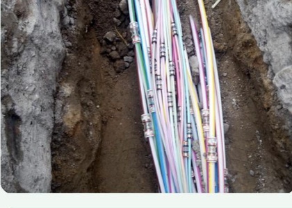 Color-coded microduct bundle installed in a trench