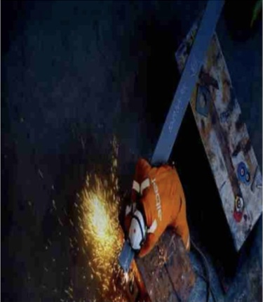 Welder cutting and preparing a structural steel component